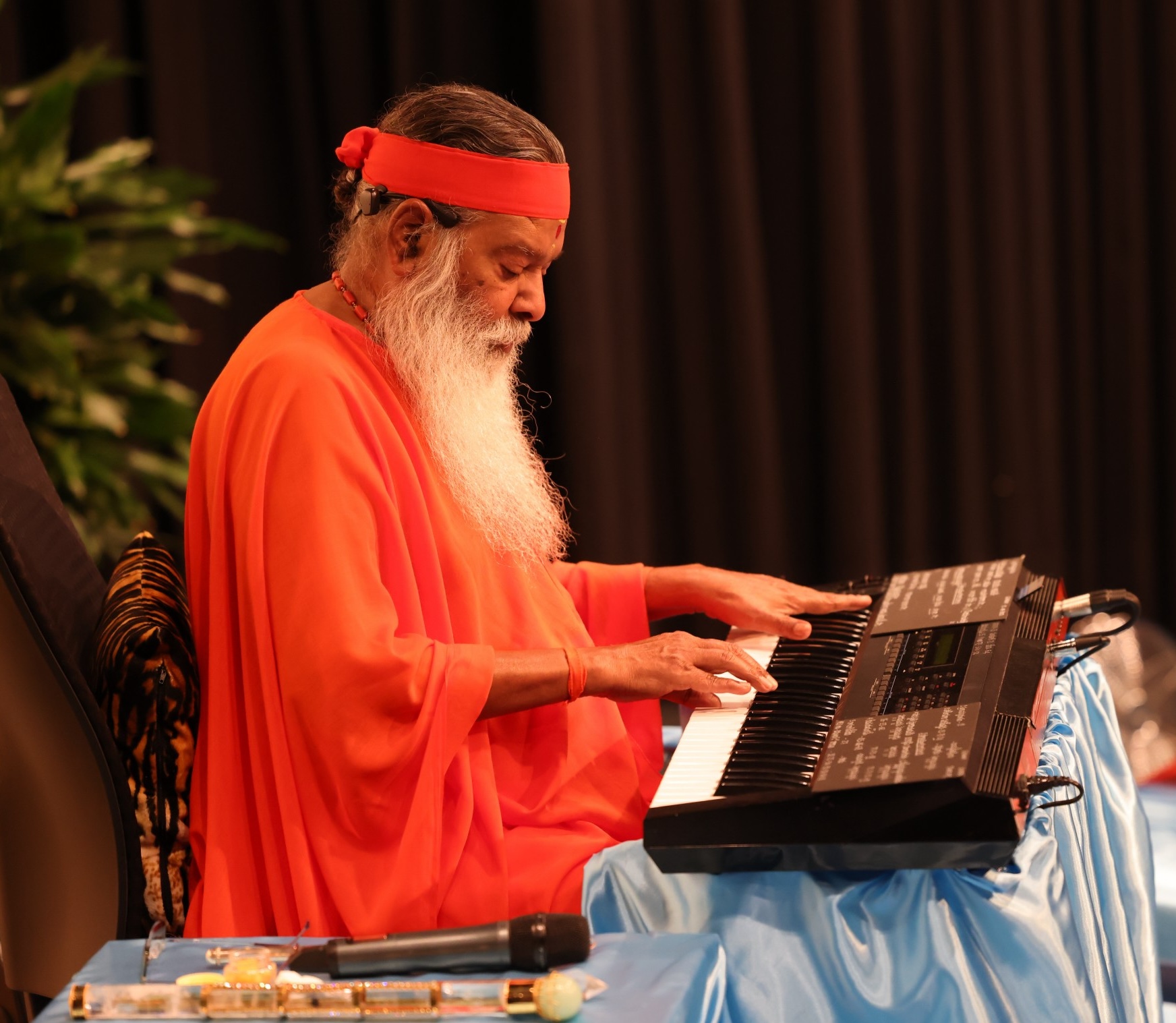 Sri Swamiji at keyboard — concert performance